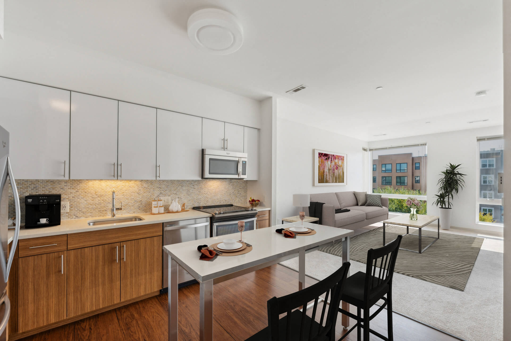 a kitchen and living room with a table and chairs